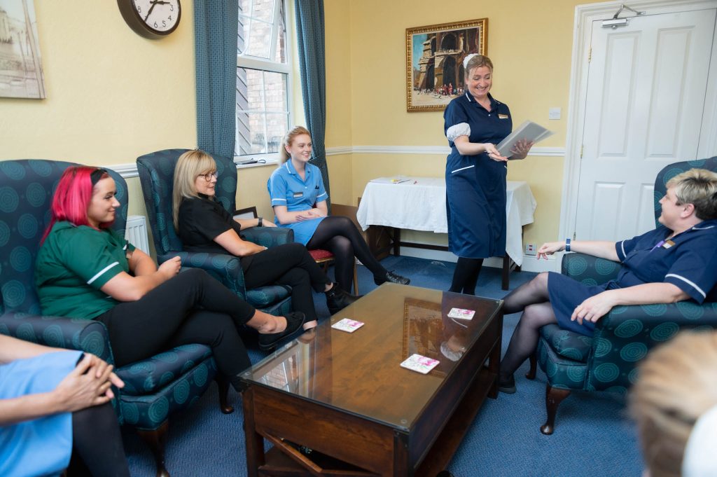 Members of staff training in the staff room.